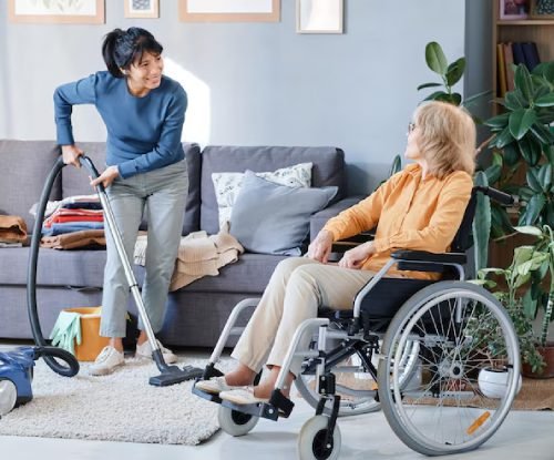 Image of a support worker assisting with light household chores like cleaning or meal prep