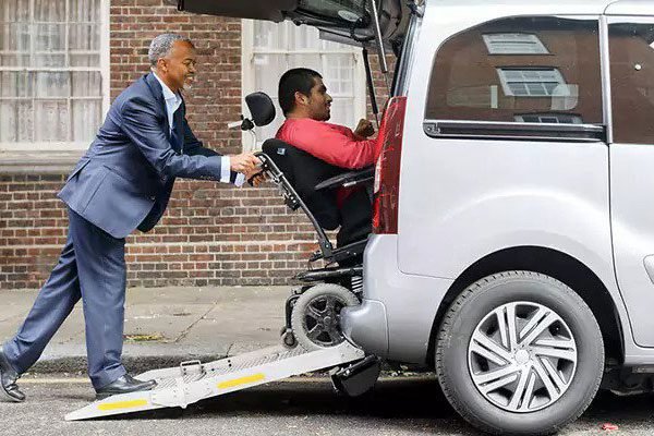 Image of an accessible vehicle or a support worker assisting a client into a car