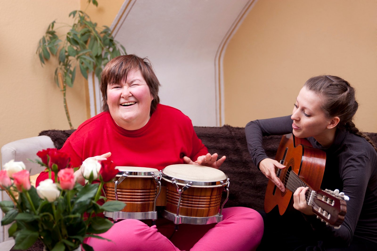 Image of a support worker and client enjoying a community event or park outing