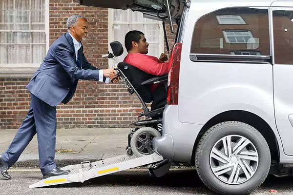 Image of an accessible vehicle or a support worker assisting a client into a car